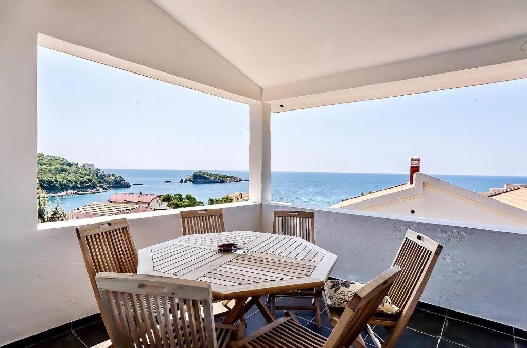 Balcony with a table and open sea view